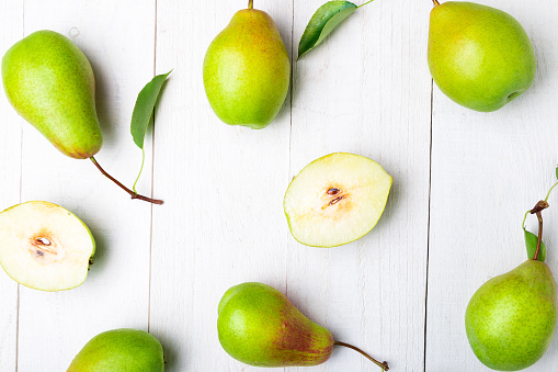 Pears background on white wooden table. Flat lay.