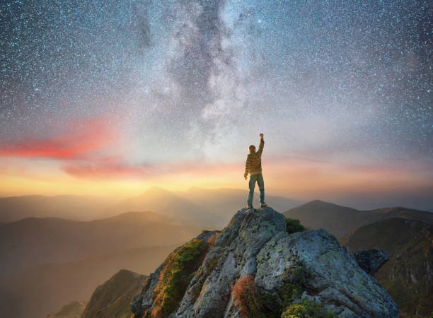 istock Silhouette of a champion on mountain peak. Active life concept 902847392