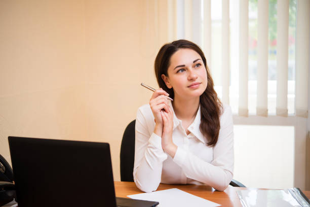 istock girl in the office makes a plan 902855466