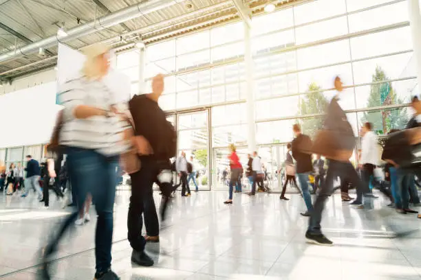 blurred people walking in a modern hall.