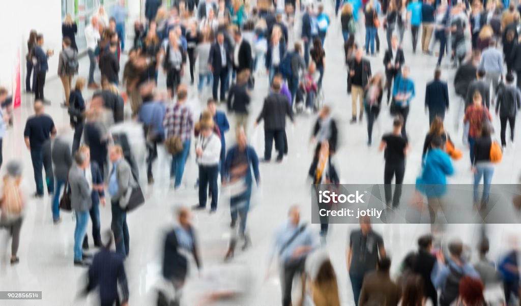 blurred people in a modern hall blurred people walking in a modern hall. Crowd of People Stock Photo