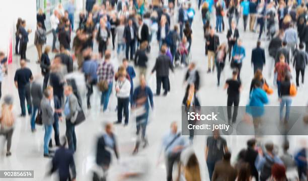 Blurred People In A Modern Hall Stock Photo - Download Image Now - Crowd of People, Tradeshow, People