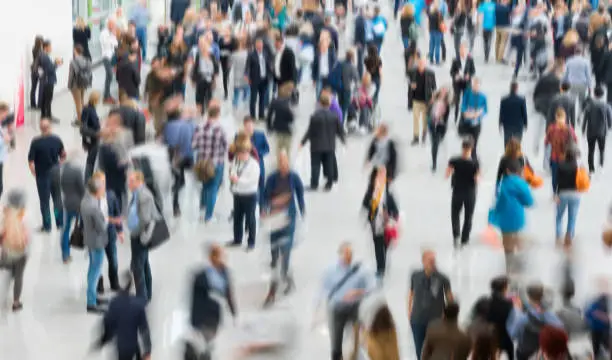 blurred people walking in a modern hall.