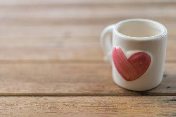 istock Cup heart shape on wooden floor in Valentine's Day 902862994