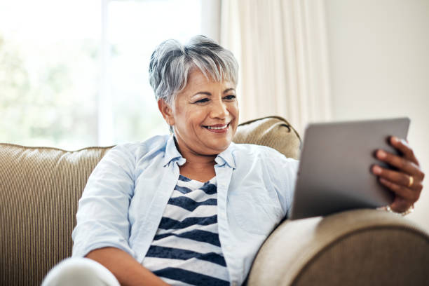 istock Catching up on her favourite shows anywhere 902863762
