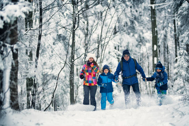 istock Father with kids enjoying beautiful winter in forest 902871232