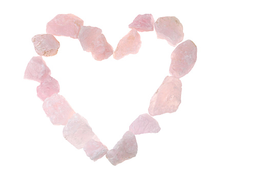 Pink quartz. heart made of pink quartz stones on white background