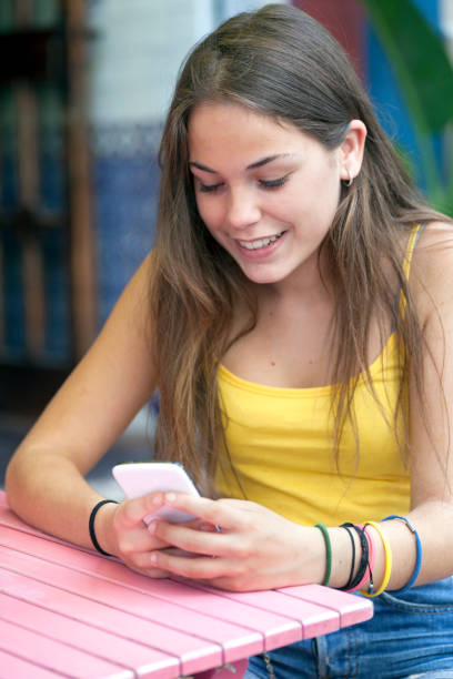 istock Girl using phone streets of Barcelona 902873934