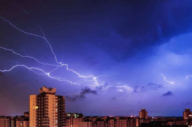 istock Thunderstorm over the city at night. 902874444