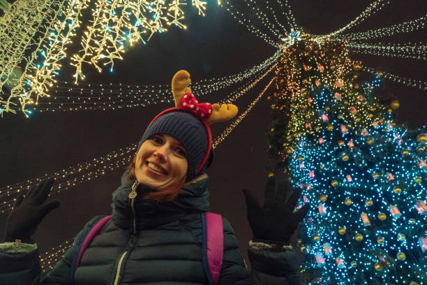 istock New Year. Girl posing near Christmas tree 902875738