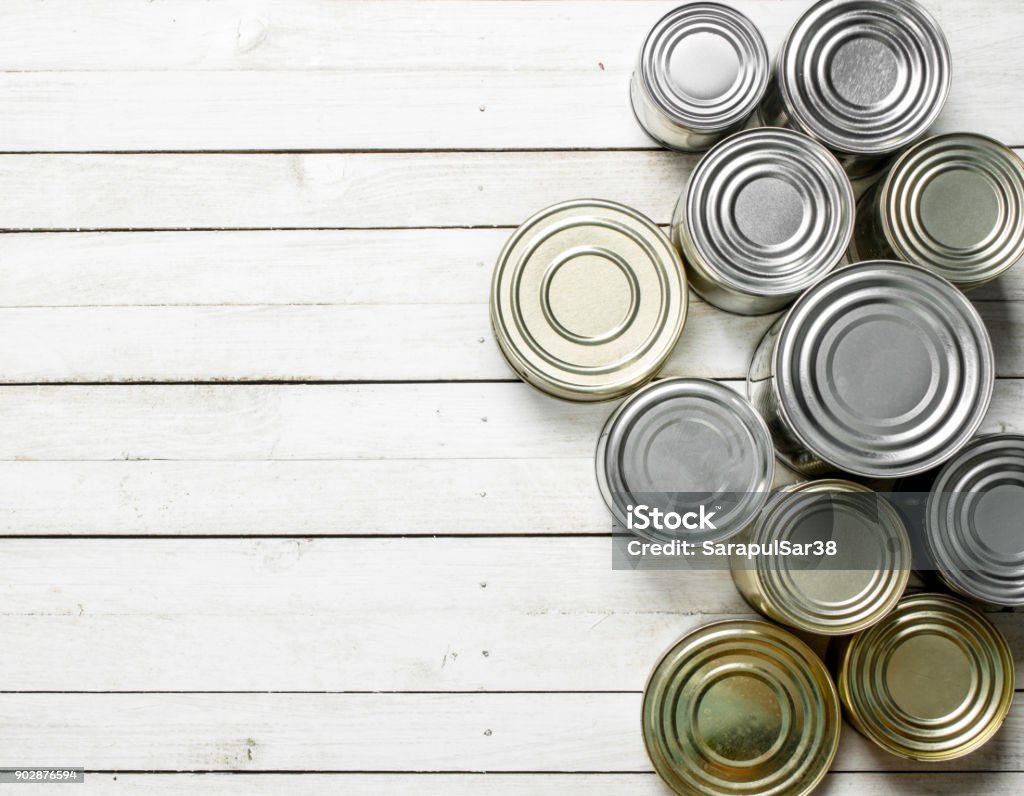 Tin cans with food. Tin cans with food. On white wooden table. Canned Food Stock Photo