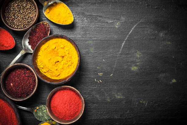 istock Ground spices in bowls and spoons. 902876726