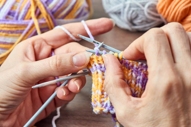 istock Young Woman Knitting 902883092