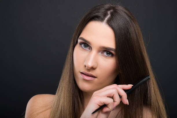 istock Beautiful female combs her healthy long hair 902886508