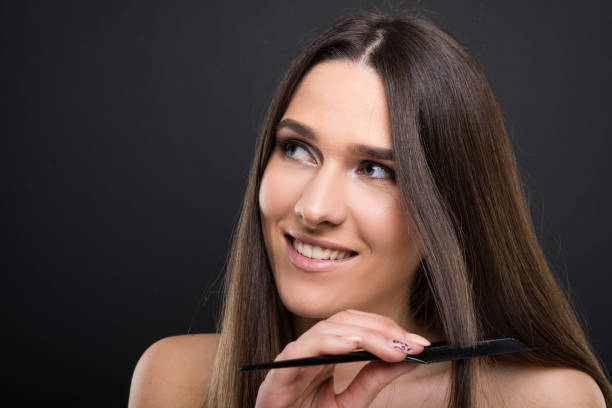istock Happy beautiful woman combing her hair 902886862