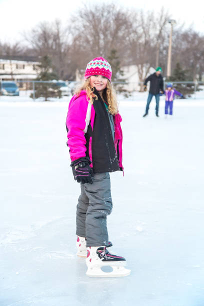 istock Girl Standing on Ice Wearing Skates 902897804