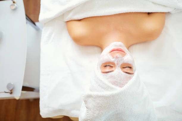 istock Woman in mask on face in spa salon 902901582