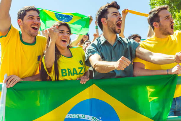 istock Brazilian supporters celebrating at stadium with flags 902902000