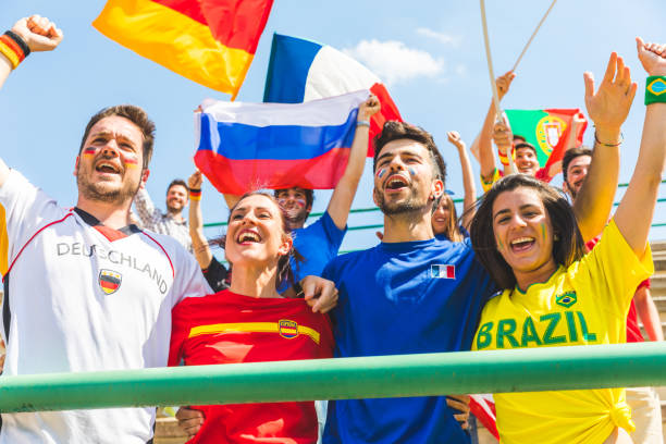 istock Happy fans supporters from different countries together at stadium 902902262