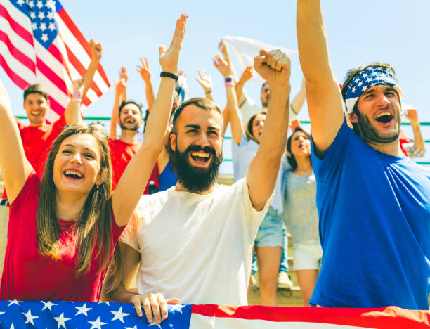 istock American fans cheering at stadium with USA flags 902902310