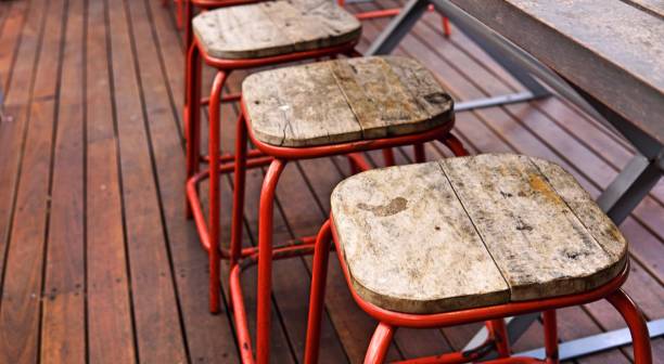 istock Empty seat in cafe shop with selective focus. Close up high stool chair at counter restaurant. Stool with wood surface and steel in modern cafe. 902905148