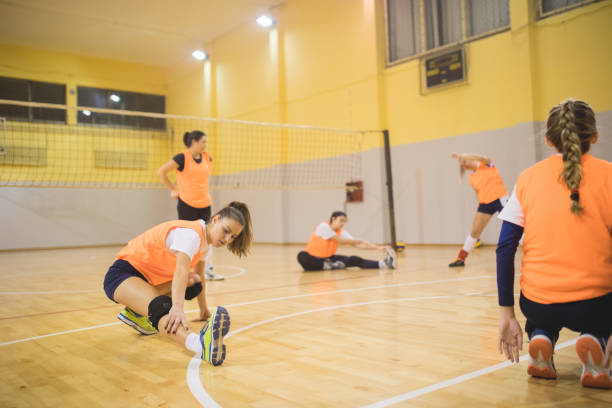 istock Female volleyball team exercising 902905858