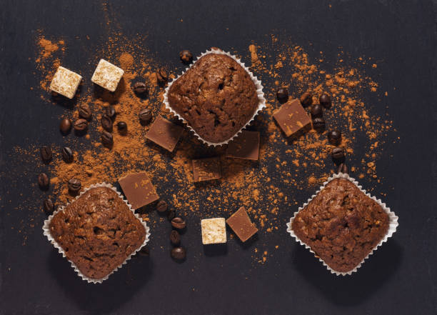 istock chocolate muffins on a gray surface with cocoa powder. View from above. 902910682