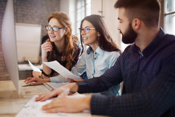 istock Group of young designers working as team 902914256