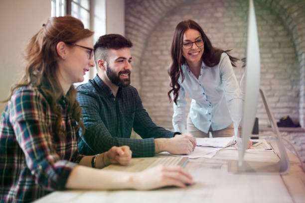 istock Group of young designers working as team 902916374