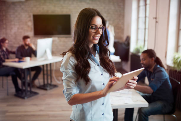 Portrait of young beautiful female designer using tablet