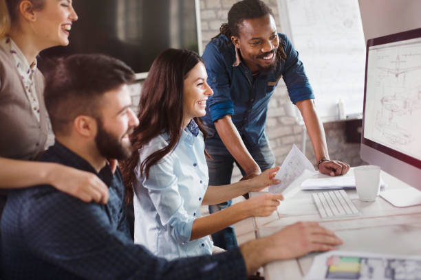 istock Group of young designers working as team 902916720