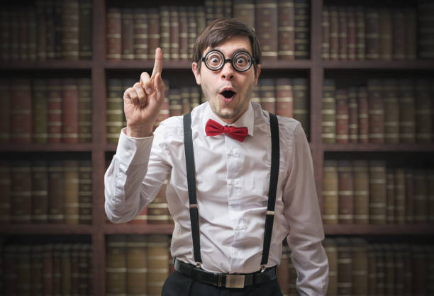 Funny young man (nerd) with finger up has an idea. Funny young man (nerd) with finger up has an idea. nerd stock pictures, royalty-free photos & images