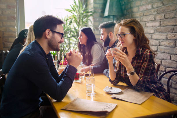 istock Handsome man flirting with cute woman in restaurant 902917046