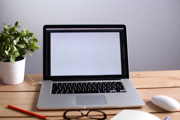 istock Laptop stands on a wooden table 902917662