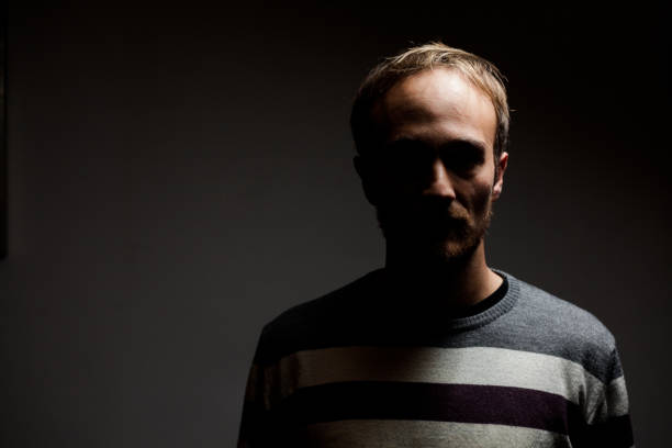 istock Man in the Dark Portrait 902920746