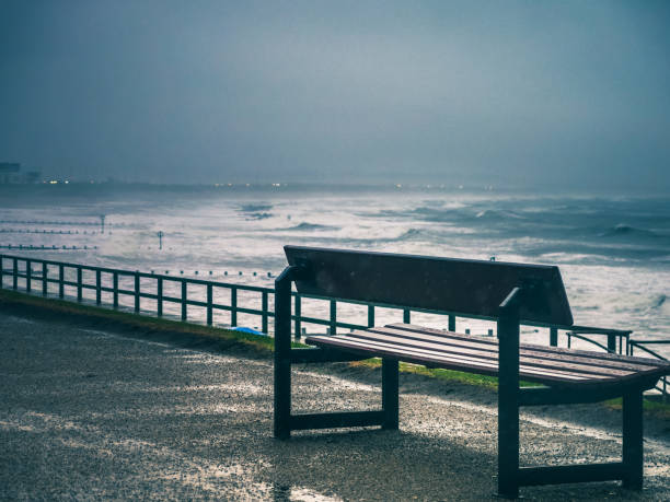 istock Memorial park bench looking out to stormy sea 902920952