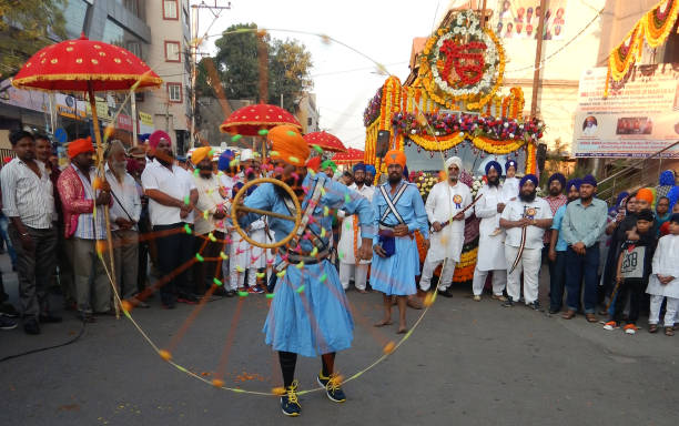 Indian Sikh youth show Gatka sikh martial art form in Nagar Keertan celebrating birth anniversary of Guru Gobind singh stock photo