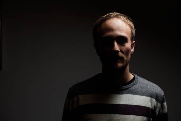 istock Man in the Dark Portrait 902921834