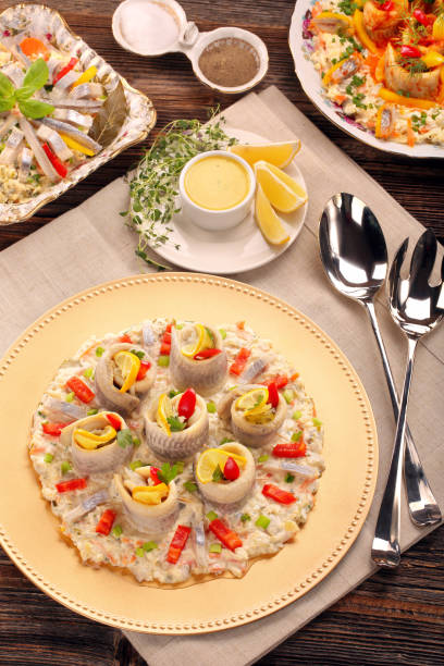 istock Rolled christmas herrings with fish salad and lemon 902922108