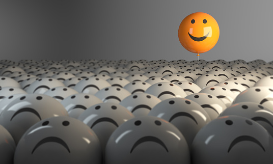 Smiling Sphere Balloon in the middle of grey crowd. ( 3d render )\n