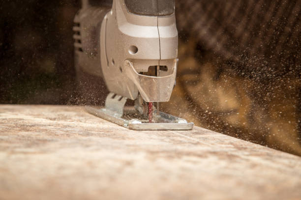 istock Master cuts wood with a jig saw 902922734