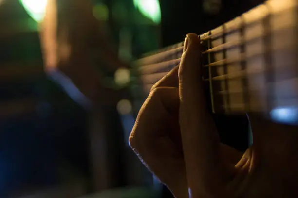 Photo of Musician man is playing the guitar