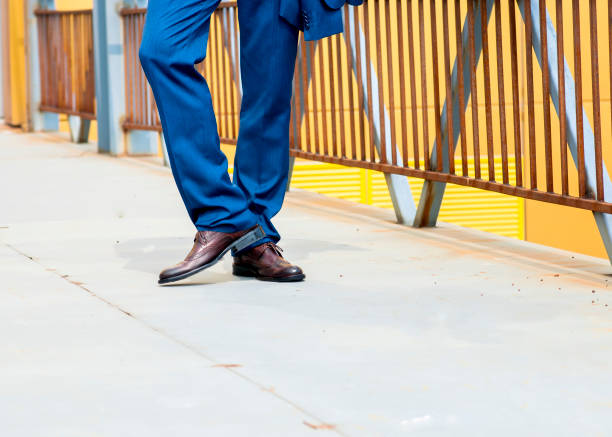 istock man wears blue trousers with brown shoes 902933996