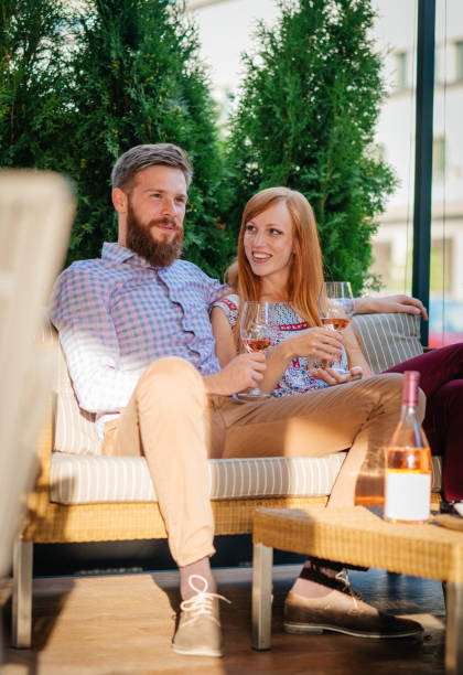 istock Loving couple ordering dinner in outdoor snack bar and drinking wine 902939894