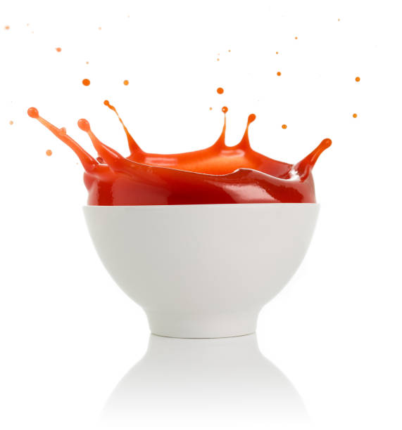 tomato soup splashing on white background stock photo