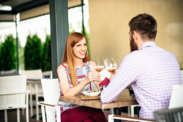istock Redhead woman and her man drinking wine and having light snack in restaurant 902944660