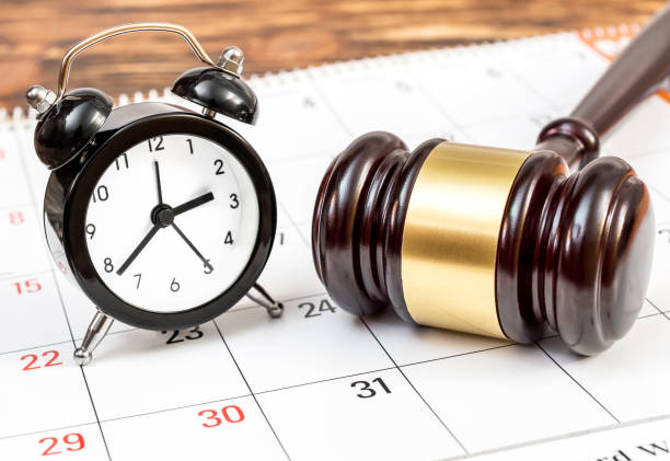 Judge's gavel with clock and calendar on the table. stock photo