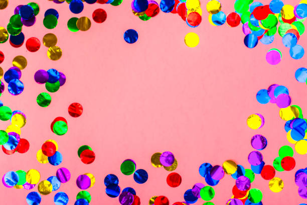 istock Colorful confetti on pink background 902945324