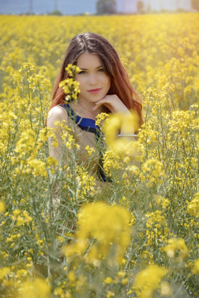 istock Girl in colza field 902949916