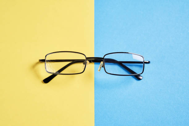istock Eyewear placed on a pastel yellow and blue background divides the halves. 902950664